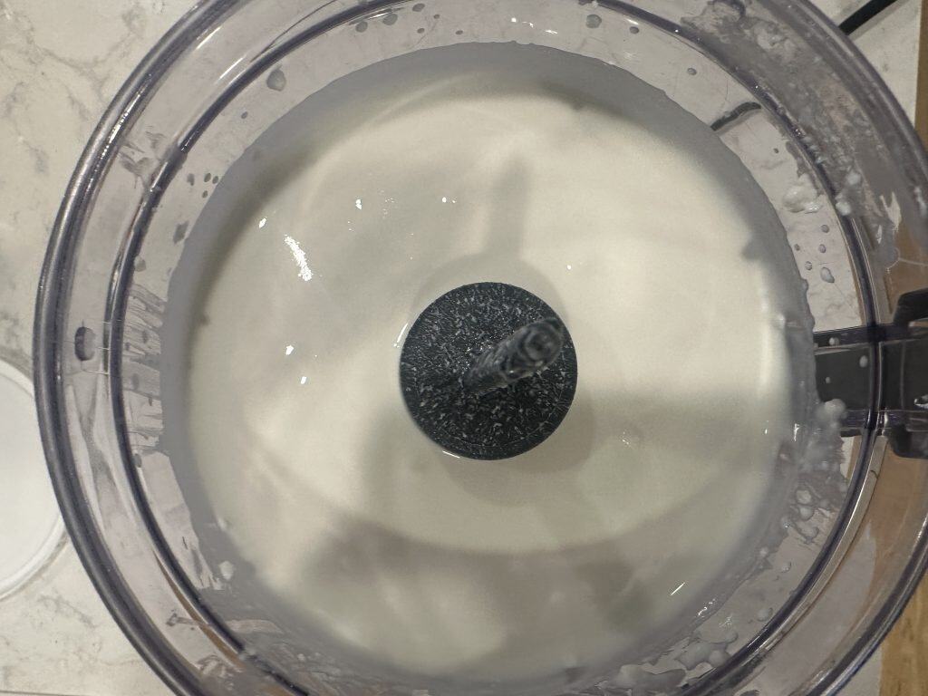Pulsing cottage cheese in a food processor until smooth
