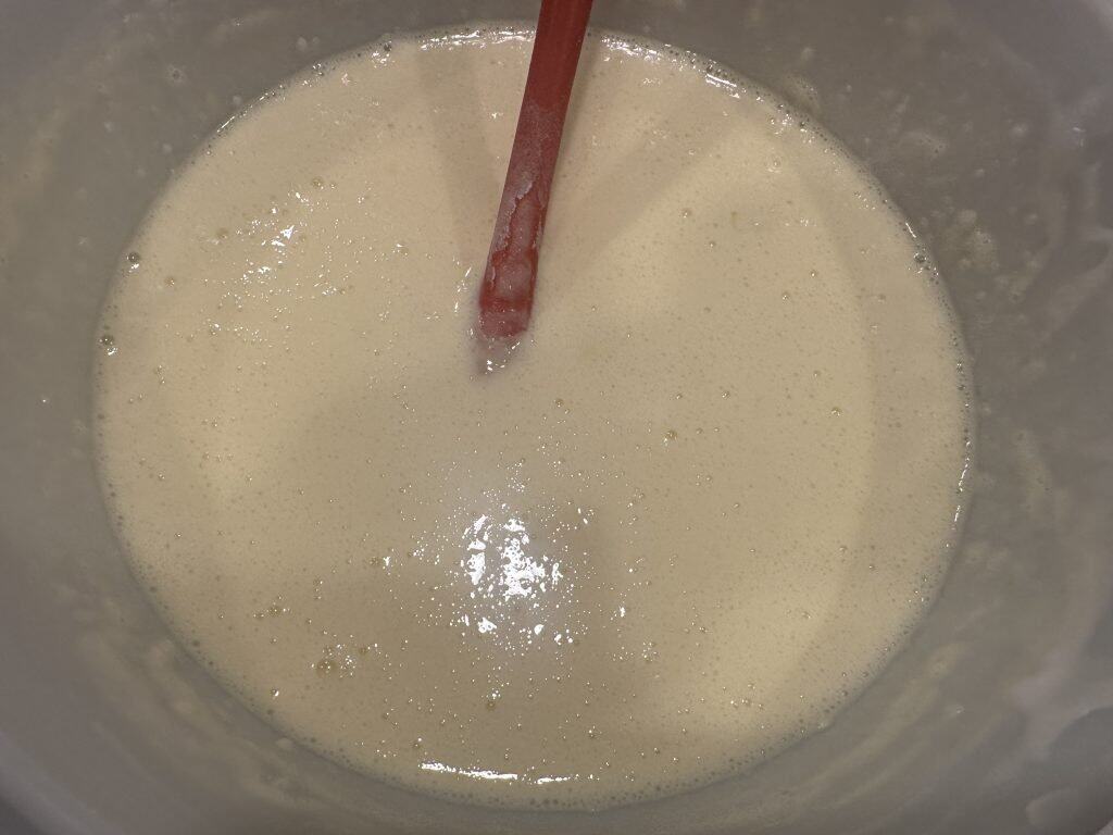 Combining all the cheesecake ingredients in a bowl