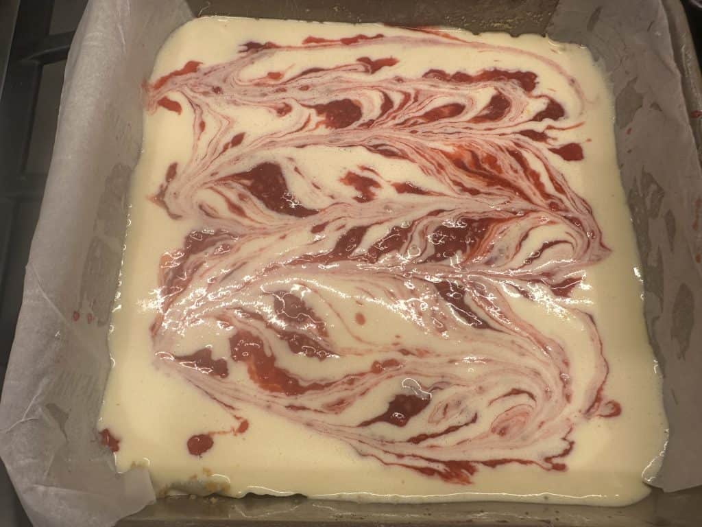 Raspberry sauce spread across top