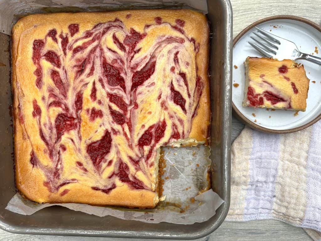 high protein raspberry swirl cheesecake bars with protein crust