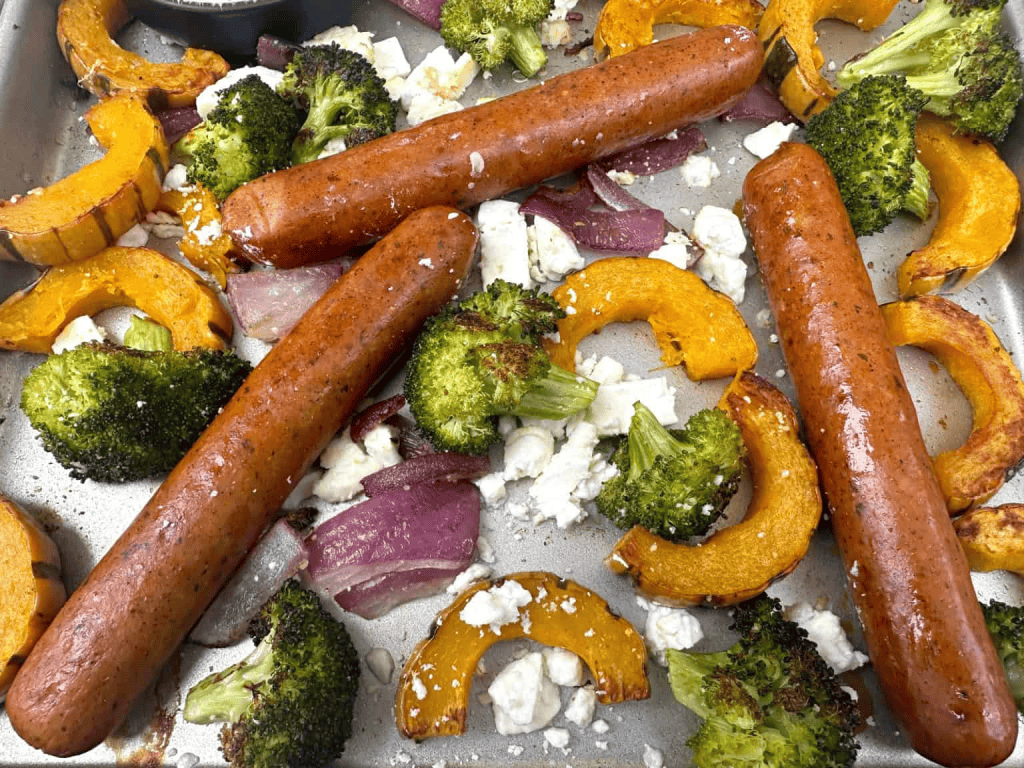 Sheet pan with sausages, broccoli, onion, squash and feta