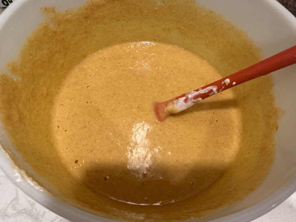 all ingredients in a bowl stirred except cubed bread